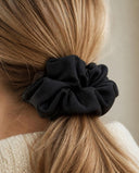 Close-up of the Classic Black kimono scrunchie worn on a low ponytail