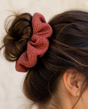 Close-up of the Rose Red Pinstripe kimono scrunchie worn on a messy bun
