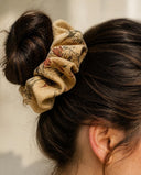 Close-up of the Beige Vintage Floral kimono scrunchie worn on a messy bun