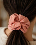 Close-up of the Peach Speckle kimono scrunchie worn on a low ponytail