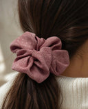 Close-up of the Dusty Rose kimono scrunchie worn on a low ponytail
