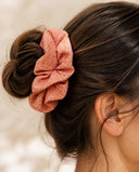 Close-up of the Peach Speckle kimono scrunchie worn on a messy bun