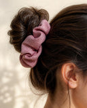 Close-up of the Dusty Rose kimono scrunchie worn on a messy bun