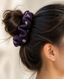 Close-up of the Purple Falling Petals kimono scrunchie worn on a messy bun