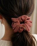 Close-up of the Brick Rose kimono scrunchie worn on a low ponytail