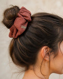 Close-up of the Brick Rose kimono scrunchie worn on a messy bun