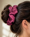 Close-up of the Raspberry Pink kimono scrunchie worn on a messy bun