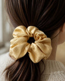 Close-up of the Golden Damask kimono scrunchie worn on a low ponytail