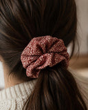 Close-up of the Brick Red Speckle kimono scrunchie worn on a low ponytail