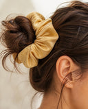 Close-up of the Golden Damask kimono scrunchie worn on a messy bun