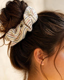 Close-up of the Cream Pinstripe kimono scrunchie worn on a messy bun