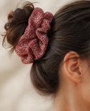 Close-up of the Brick Red Speckle kimono scrunchie worn on a messy bun