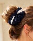 Close-up of the Navy & White Stripe kimono scrunchie worn on a messy bun