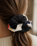 Close-up of the Black & Ivory Floral kimono scrunchie worn on a low ponytail