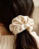 Close-up of the Ivory Silk kimono scrunchie worn on a low ponytail