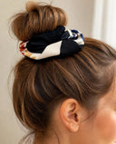 Close-up of the Black & Ivory Floral kimono scrunchie worn on a messy bun