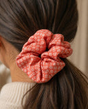 Close-up of the Coral Diamond Grid kimono scrunchie worn on a low ponytail