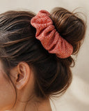 Close-up of the Coral Diamond Grid kimono scrunchie worn on a messy bun