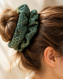 Close-up of the Green Floral Line kimono scrunchie worn on a messy bun