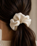 Close-up of the Natural Cream kimono scrunchie worn on a low ponytail