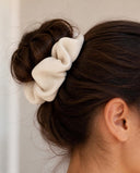 Close-up of the Natural Cream kimono scrunchie worn on a messy bun