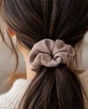 Close-up of the Sand Taupe kimono scrunchie worn on a low ponytail