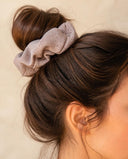Close-up of the Sand Taupe kimono scrunchie worn on a messy bun