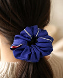 Close-up of the Royal Blue kimono scrunchie worn on a low ponytail