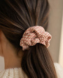 Close-up of the Coral Lattice kimono scrunchie worn on a low ponytail
