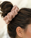 Close-up of the Coral Lattice kimono scrunchie worn on a messy bun