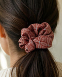 Close-up of the Plum Starflower kimono scrunchie worn on a low ponytail