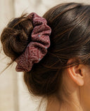 Close-up of the Plum Starflower kimono scrunchie worn on a messy bun
