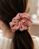 Close-up of the Coral Petal Print kimono scrunchie worn on a low ponytail