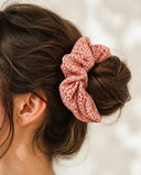 Close-up of the Coral Petal Print kimono scrunchie worn on a messy bun