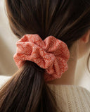 Close-up of the Salmon Kanoko Dots kimono scrunchie worn on a low ponytail