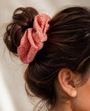 Close-up of the Salmon Kanoko Dots kimono scrunchie worn on a messy bun