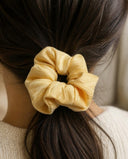 Close-up of the Butter Yellow kimono scrunchie worn on a low ponytail