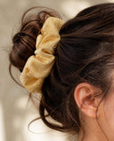 Close-up of the Butter Yellow kimono scrunchie worn on a messy bun