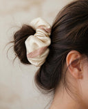 Close-up of the Cream & Peach Patchwork kimono scrunchie worn on a messy bun
