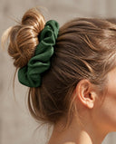 Close-up of the Forest Green kimono scrunchie worn on a messy bun