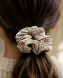 Close-up of the Ivory Ink Botanical kimono scrunchie worn on a low ponytail