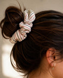 Close-up of the Cream & Rose Stripe kimono scrunchie worn on a messy bun