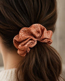 Close-up of the Rust Starry Dots kimono scrunchie worn on a low ponytail