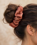 Close-up of the Rust Starry Dots kimono scrunchie worn on a messy bun