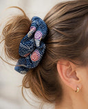 Close-up of the Navy & Pink Floral kimono scrunchie worn on a messy bun