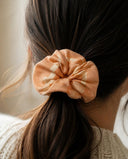 Close-up of the Apricot Bloom kimono scrunchie worn on a low ponytail