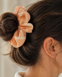 Close-up of the Apricot Bloom kimono scrunchie worn on a messy bun