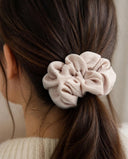 Close-up of the Blush Ivory kimono scrunchie worn on a low ponytail