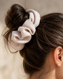 Close-up of the Blush Ivory kimono scrunchie worn on a messy bun
