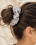 Close-up of the White & Black Dot kimono scrunchie worn on a messy bun